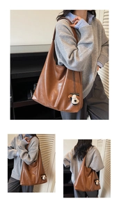 Detail of a brown tote bag with premium leather texture and a cute dog plush keychain