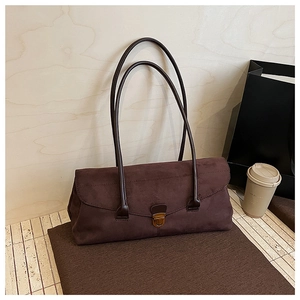 Detail of vintage matte brown shoulder bag with bronze twist lock and suede texture