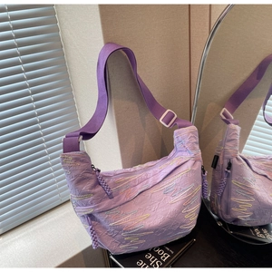 Macro shot of light purple pleated crescent bag featuring colorful wave embroidery