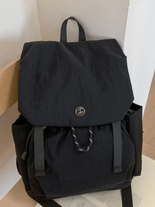Minimalist black canvas backpack with flap drawstring closure and GM logo for campus use