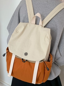 Minimalist canvas backpack in beige and orange color-block style for casual daily use
