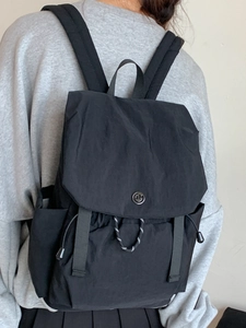 Minimalist black waterproof canvas backpack for women with wide straps and drawstring