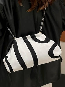 Modern black and white striped knit cloud bag with silver metal chain shoulder strap
