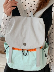 Women's light canvas backpack in gray and mint green patchwork design for college