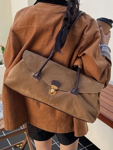 Vintage caramel brown suede tote bag with bronze metal lock and long shoulder handles
