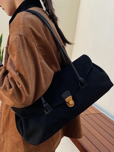 Retro black matte shoulder bag with gold metal clasp shown on a shoulder for 2025 fashion