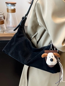 Vintage black oil wax leather crescent shoulder bag with a cute plush dog pendant charm