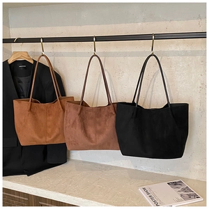 Detailed display of large suede tote bags in brown, coffee, and black for daily use