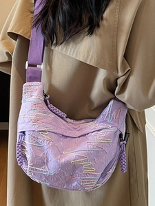 Purple textured crossbody bag with multi-color wave embroidery and wide strap