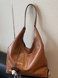 Deep brown oversized hobo shoulder bag with a cute white plush lamb charm accessory