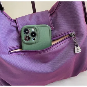 Macro shot of a purple tote bag side pocket with a smartphone inside showing large capacity