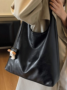 Retro black faux leather tote bag with glossy crinkle texture and cute puppy charm