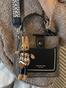 Retro bucket bag for women with woven strap and cute rabbit pendant in grey and black