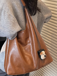 Vintage caramel brown leather tote bag for women with cute plush puppy charm