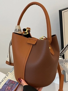 Litchi pattern leather bucket bag in contrast brown colors with a fashion ribbon