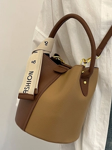 Chic two-tone bucket bag with litchi texture and fashion ribbon, elegant hand-held style