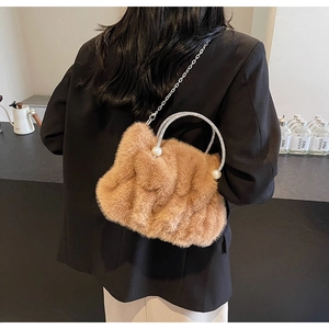 Détail du sac à main en fausse fourrure marron avec poignée strass et perles