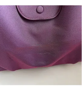 Close-up of purple nylon tote bag featuring logo print and high-quality textured fabric