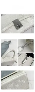 Detailed views of white snakeskin texture handbag with silver hardware lock and metal hooks