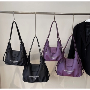 Nylon tote bags in black and violet featuring a wrinkled texture and side metal zipper detail