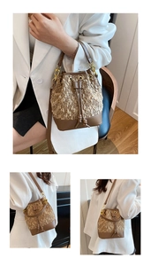 Close-up of contrast stitching bucket bag featuring brown leather and textured fabric