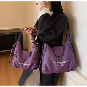 Comparison showing large and small purple nylon tote bags with metallic charms