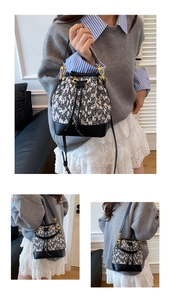 Close-up of contrast tweed bucket bag with black leather trim and gold hardware