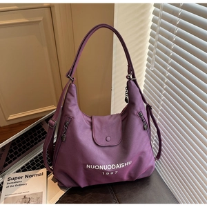Detail view of purple nylon hobo bag featuring large capacity and multiple zipper pockets