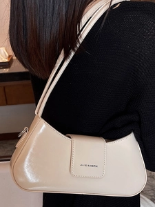 Chic beige crescent underarm bag in glossy leather finish for women with dual straps