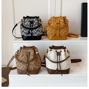 Close-up of stylish bucket bags in various fabrics with drawstring and metal rings