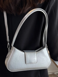 Chic silver metallic underarm bag with sleek leather texture for modern fashion aesthetics