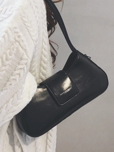 Chic black faux leather underarm bag for women featuring a minimalist metal logo design