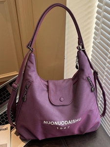 Large purple canvas hobo tote bag for women featuring white branding and zip details