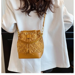 Detail of drawstring bucket bag with ginger velvet and smooth brown leather patchwork
