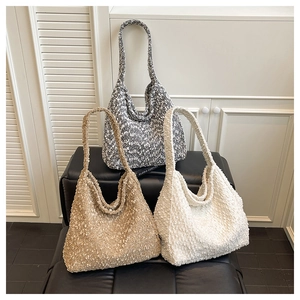Close-up of soft faux shearling teddy tote bags in three seasonal autumn colors