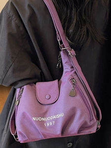 Minimalist purple canvas tote bag with adjustable strap and white lettering print