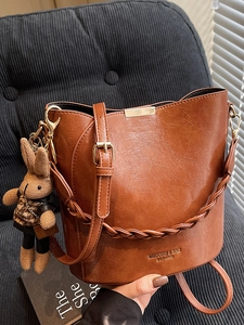 Women Vintage PU Leather Bucket Bag Minimalist Shoulder Crossbody Bag Urban Fashion Handbag With Rabbit Charm And Woven Strap