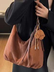 Retro dark brown suede hobo bag for women with leather tassels and plush puppy charm