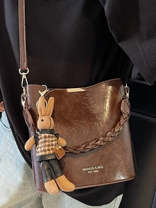 Brown PU leather bucket bag with braided handle and cute rabbit charm for women