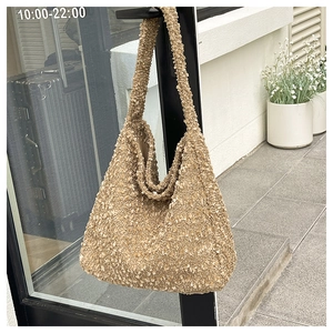 Detail shot of khaki lamb wool tote bag showing its fuzzy texture and minimalist design