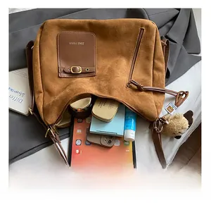 Brown suede tote bag interior showing large capacity for tablet and cosmetics