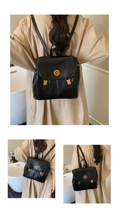 Détail d'un sac à dos en similicuir noir avec un fermoir rotatif doré élégant