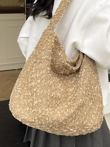 Minimalist beige bouclé tote bag with spacious hobo design for women on a shoulder