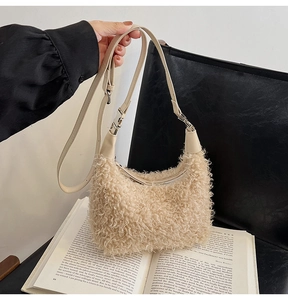 Détail du sac à bandoulière en peluche beige avec bandoulière en cuir et fermeture éclair