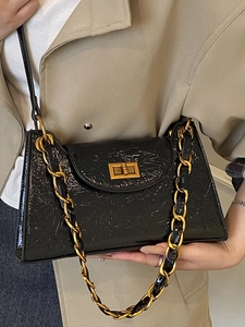 French vintage black leather underarm bag with gold chain and glossy cracked texture