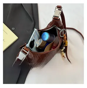 Detailed interior capacity of dark brown woven crossbody bag with daily essentials