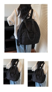 Three-way view of a lightweight black nylon backpack showing its large storage capacity