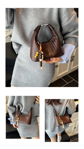 Close-up of dark brown woven leather hobo bag with unique wooden bead charm detail