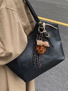 Large black leather tote bag for women with cute bear charm and gold strap buckle