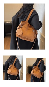 Detail view of caramel canvas tote bag with side zipper pocket and mini round coin pouch